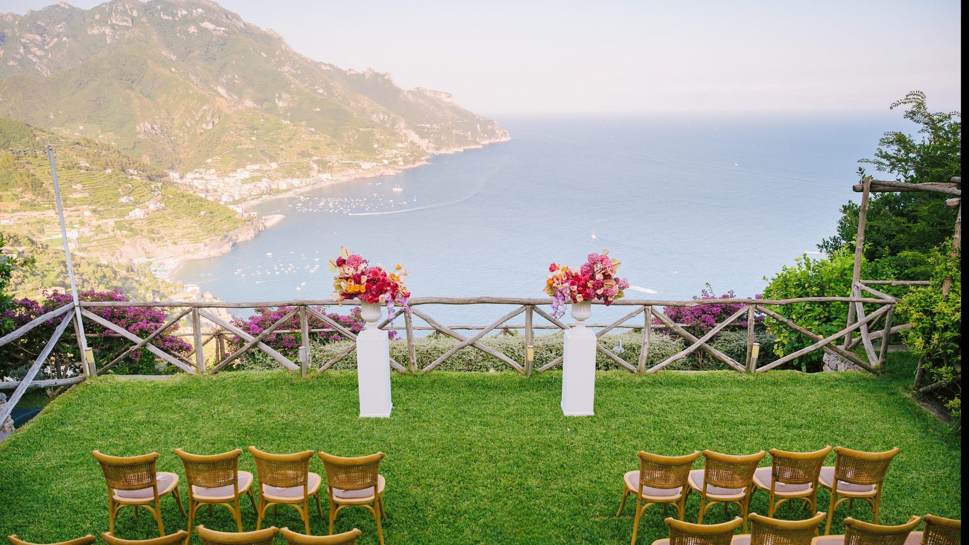 Ceremony set up on the lawn at Villa Mariella, chairs facing the sea and the coast below Ravello